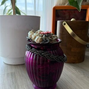 Purple Decorative Vase stuffed with a variety of jewelry.